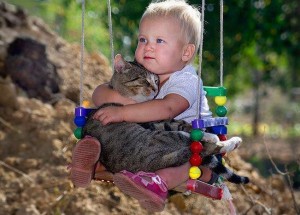 baby with cat in swing  - CUTE